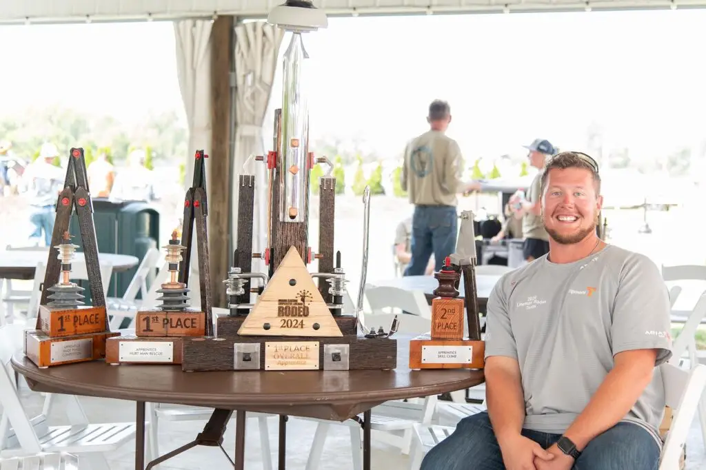 Tipmont lineman Tristan Hoffman seated with trophies from the 2024 Indiana Lineman Rodeo