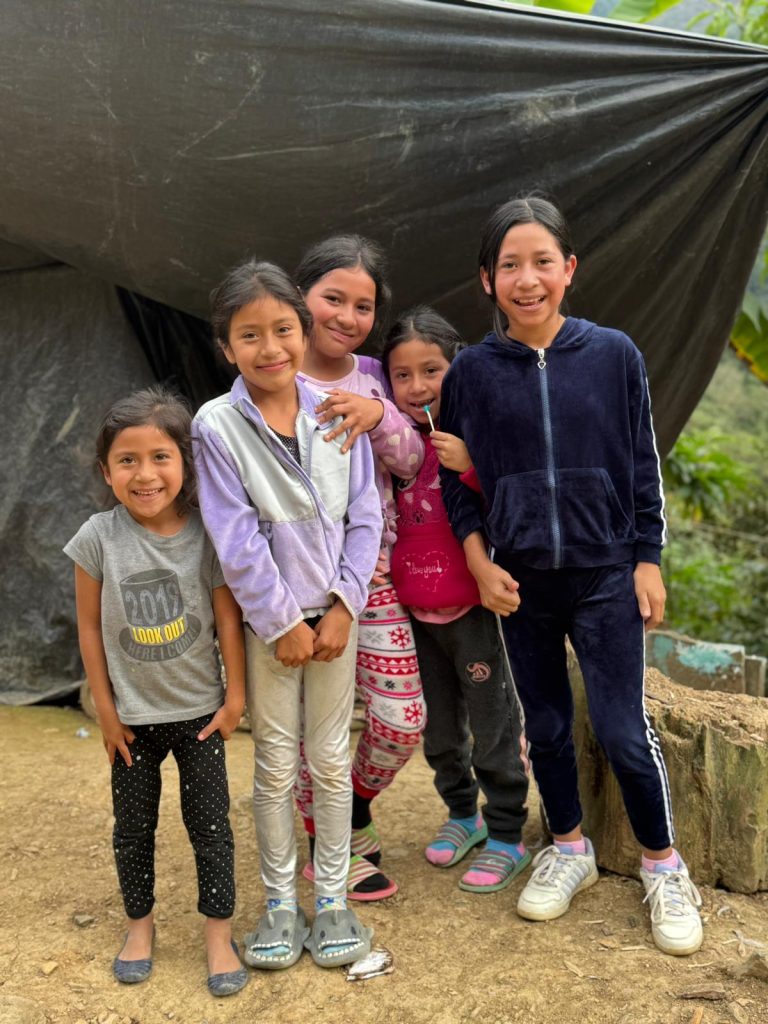 Young children in a Guatemalan village smile.
